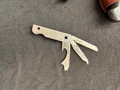 A VARIETY OF KNIVES AND A SHARPENING STONE