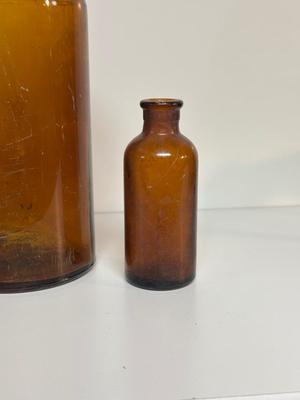 BROWN GLASS JUG AND BOTTLES