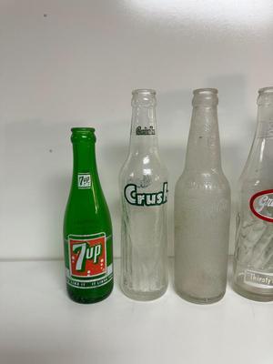 A VARIETY OF GLASS SODA POP BOTTLES