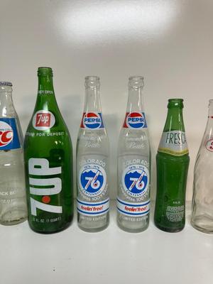 A VARIETY OF GLASS SODA POP BOTTLES