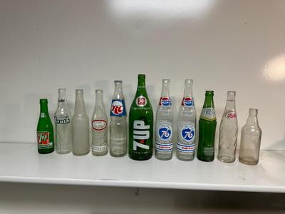 A VARIETY OF GLASS SODA POP BOTTLES
