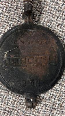HIBBARD CAST IRON WAFFLE MAKER AND A FUEL JUG TO KEEP THE WAFFLES COOKING