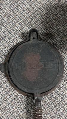 HIBBARD CAST IRON WAFFLE MAKER AND A FUEL JUG TO KEEP THE WAFFLES COOKING