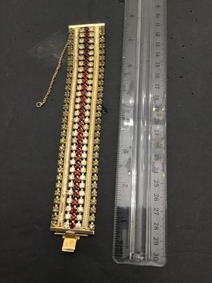 Sale Photo Thumbnail #198: This is a beautiful vintage Hobe bracelet, clear and red rhinestones, gold tone bracelet. Please see attached photos.