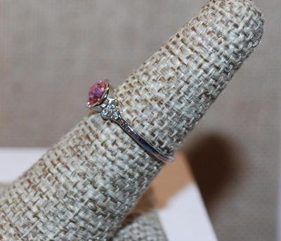 Size 6½ Single Pink Faceted Center Stone Set in a "Nest" Ring with 3 Clear Stones Side Accents and Silver Tone Band (1.2g)