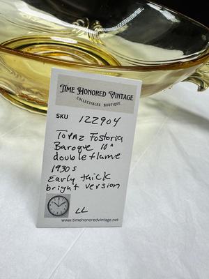 Sale Photo Thumbnail #95: 1930s amber yellow color shows slight signs of use , and has some black crumbs stuck in the edge of one of the wings. I have not cleaned aggressively. Winged plume handles sh0w off this rare topaz color Art Deco piece.