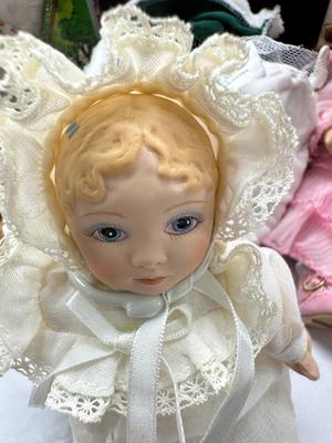 Sale Photo Thumbnail #133: German and French bru Spanish Dancer, plastic doll without her head. madam Alexander book. Porcelain babies, soft ethnic dolls. I found the other boot for the wood chopper. There are 2 music box dolls, and a Raggedy Andy. 2 bells