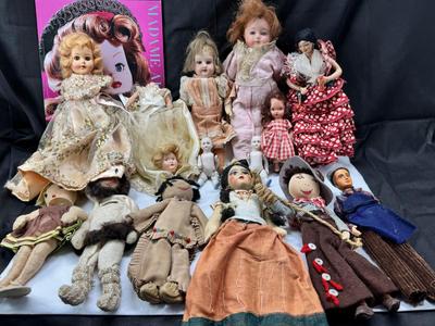 Sale Photo Thumbnail #97: German and French bru Spanish Dancer, plastic doll without her head. madam Alexander book. Porcelain babies, soft ethnic dolls. I found the other boot for the wood chopper. There are 2 music box dolls, and a Raggedy Andy. 2 bells