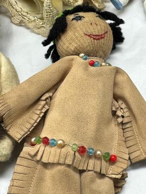 Sale Photo Thumbnail #111: German and French bru Spanish Dancer, plastic doll without her head. madam Alexander book. Porcelain babies, soft ethnic dolls. I found the other boot for the wood chopper. There are 2 music box dolls, and a Raggedy Andy. 2 bells