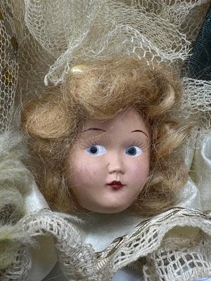 Sale Photo Thumbnail #115: German and French bru Spanish Dancer, plastic doll without her head. madam Alexander book. Porcelain babies, soft ethnic dolls. I found the other boot for the wood chopper. There are 2 music box dolls, and a Raggedy Andy. 2 bells