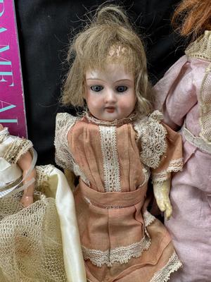 Sale Photo Thumbnail #100: German and French bru Spanish Dancer, plastic doll without her head. madam Alexander book. Porcelain babies, soft ethnic dolls. I found the other boot for the wood chopper. There are 2 music box dolls, and a Raggedy Andy. 2 bells