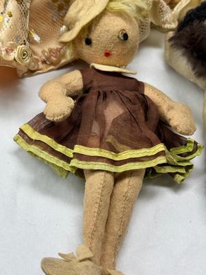 Sale Photo Thumbnail #112: German and French bru Spanish Dancer, plastic doll without her head. madam Alexander book. Porcelain babies, soft ethnic dolls. I found the other boot for the wood chopper. There are 2 music box dolls, and a Raggedy Andy. 2 bells