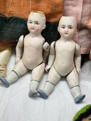 Sale Photo Thumbnail #114: German and French bru Spanish Dancer, plastic doll without her head. madam Alexander book. Porcelain babies, soft ethnic dolls. I found the other boot for the wood chopper. There are 2 music box dolls, and a Raggedy Andy. 2 bells