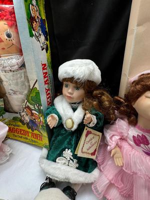 Sale Photo Thumbnail #122: German and French bru Spanish Dancer, plastic doll without her head. madam Alexander book. Porcelain babies, soft ethnic dolls. I found the other boot for the wood chopper. There are 2 music box dolls, and a Raggedy Andy. 2 bells