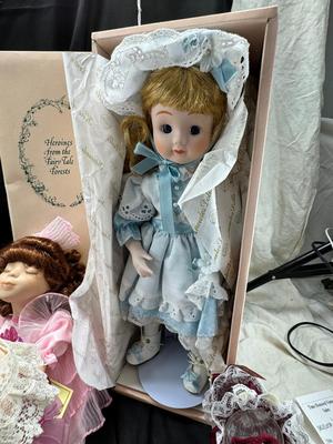 Sale Photo Thumbnail #120: German and French bru Spanish Dancer, plastic doll without her head. madam Alexander book. Porcelain babies, soft ethnic dolls. I found the other boot for the wood chopper. There are 2 music box dolls, and a Raggedy Andy. 2 bells