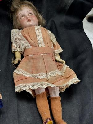 Sale Photo Thumbnail #105: German and French bru Spanish Dancer, plastic doll without her head. madam Alexander book. Porcelain babies, soft ethnic dolls. I found the other boot for the wood chopper. There are 2 music box dolls, and a Raggedy Andy. 2 bells