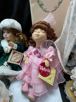 Sale Photo Thumbnail #121: German and French bru Spanish Dancer, plastic doll without her head. madam Alexander book. Porcelain babies, soft ethnic dolls. I found the other boot for the wood chopper. There are 2 music box dolls, and a Raggedy Andy. 2 bells