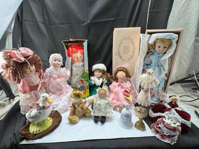 Sale Photo Thumbnail #117: German and French bru Spanish Dancer, plastic doll without her head. madam Alexander book. Porcelain babies, soft ethnic dolls. I found the other boot for the wood chopper. There are 2 music box dolls, and a Raggedy Andy. 2 bells