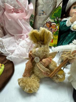 Sale Photo Thumbnail #128: German and French bru Spanish Dancer, plastic doll without her head. madam Alexander book. Porcelain babies, soft ethnic dolls. I found the other boot for the wood chopper. There are 2 music box dolls, and a Raggedy Andy. 2 bells