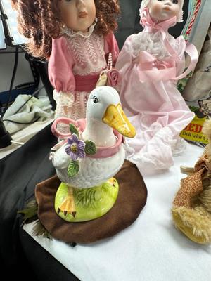 Sale Photo Thumbnail #126: German and French bru Spanish Dancer, plastic doll without her head. madam Alexander book. Porcelain babies, soft ethnic dolls. I found the other boot for the wood chopper. There are 2 music box dolls, and a Raggedy Andy. 2 bells