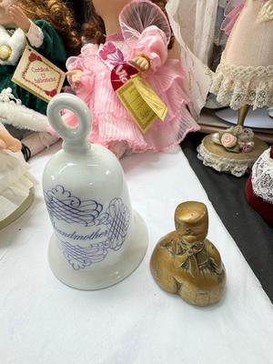 Sale Photo Thumbnail #130: German and French bru Spanish Dancer, plastic doll without her head. madam Alexander book. Porcelain babies, soft ethnic dolls. I found the other boot for the wood chopper. There are 2 music box dolls, and a Raggedy Andy. 2 bells