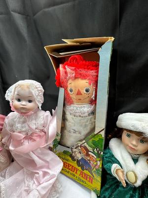 Sale Photo Thumbnail #123: German and French bru Spanish Dancer, plastic doll without her head. madam Alexander book. Porcelain babies, soft ethnic dolls. I found the other boot for the wood chopper. There are 2 music box dolls, and a Raggedy Andy. 2 bells
