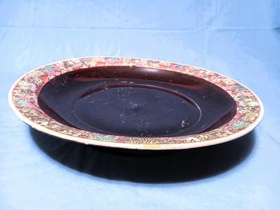 Sale Photo Thumbnail #81: Unmarked. Some wear/tape residue to black glaze. 18 1/4" diam. x 3 1/4" high.