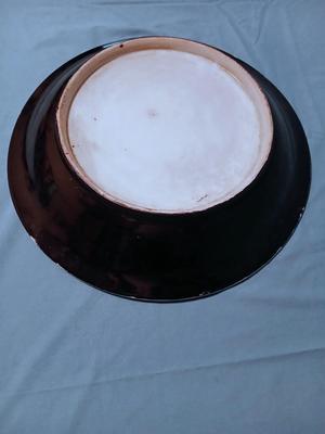 Sale Photo Thumbnail #86: Unmarked. Some wear/tape residue to black glaze. 18 1/4" diam. x 3 1/4" high.