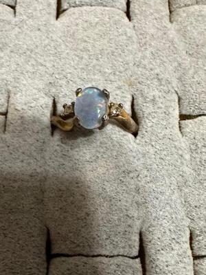 OPAL COLORED STONE RING IS 18K HGE, BEAR CLAW RING, RING WITH DOLPHINS AROUND BAND, AND A RING WITH GREEN STONE