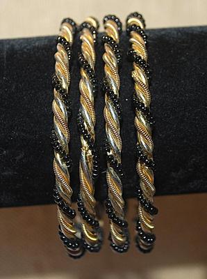 Collection of 4 Twisted IDENTICAL BRACELETS (2½" Opening) in Black, Gold & Silver Tones