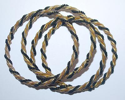 Collection of 4 Twisted IDENTICAL BRACELETS (2½" Opening) in Black, Gold & Silver Tones