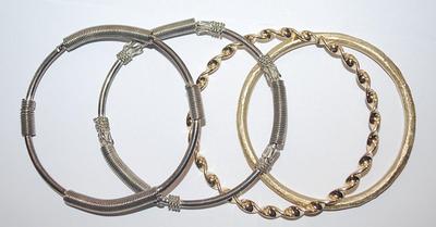 Collection of 4 BRACELETS (-2½"+ Opening) with Silver "Springs" and Brushed and Swirls Gold Tone Settings