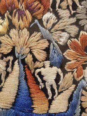 Sale Photo Thumbnail #304: Embroidery includes flowers, leaves, vines, people, animals, birds/peacocks Frame, 19 3/8" x 26", Sleeves approx. 6 1/2" x 13".