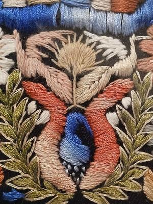 Sale Photo Thumbnail #305: Embroidery includes flowers, leaves, vines, people, animals, birds/peacocks Frame, 19 3/8" x 26", Sleeves approx. 6 1/2" x 13".