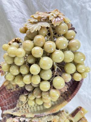 Sale Photo Thumbnail #272: Realistic grapes in a basket sits on  the raw rock base. Very large and heavy Rock sculpture, cannot be shipped. 16" tall with original padded box.