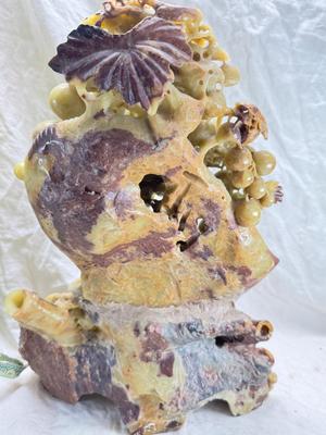 Sale Photo Thumbnail #274: Realistic grapes in a basket sits on  the raw rock base. Very large and heavy Rock sculpture, cannot be shipped. 16" tall with original padded box.