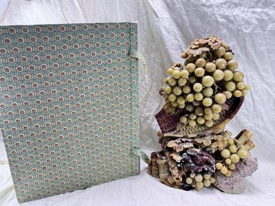 Sale Photo Thumbnail #270: Realistic grapes in a basket sits on  the raw rock base. Very large and heavy Rock sculpture, cannot be shipped. 16" tall with original padded box.