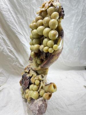 Sale Photo Thumbnail #276: Realistic grapes in a basket sits on  the raw rock base. Very large and heavy Rock sculpture, cannot be shipped. 16" tall with original padded box.