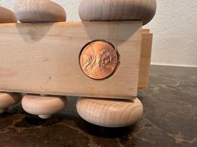 HAND CRAFTED WOODEN TOYS WITH AN EMBEDDED PENNY FOR THE YEAR THEY WERE MADE