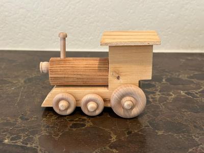 HAND CRAFTED WOODEN TOYS WITH AN EMBEDDED PENNY FOR THE YEAR THEY WERE MADE