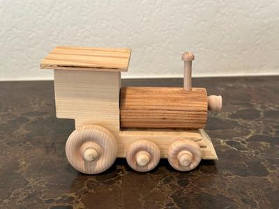 HAND CRAFTED WOODEN TOYS WITH AN EMBEDDED PENNY FOR THE YEAR THEY WERE MADE