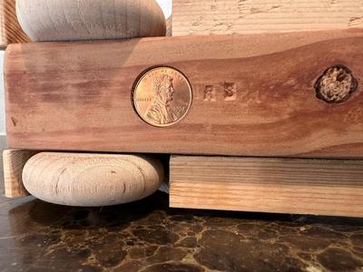 HAND CRAFTED WOODEN TOYS WITH AN EMBEDDED PENNY FOR THE YEAR THEY WERE MADE
