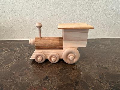 HAND CRAFTED WOODEN TOYS WITH AN EMBEDDED PENNY FOR THE YEAR THEY WERE MADE