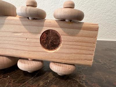 HAND CRAFTED WOODEN TOYS WITH AN EMBEDDED PENNY FOR THE YEAR THEY WERE MADE