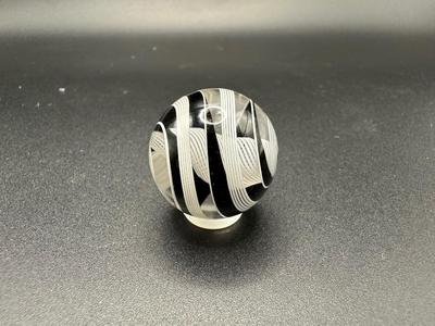 WHITE LATTICINIO SWIRL CORE MARBLE WITH BLACK AND WHITE SWIRLS