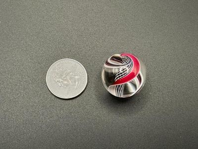 BLACK AND WHITE LATTICINIO CORE MARBLE WITH WHITE, RED, BLACK RIBBONS