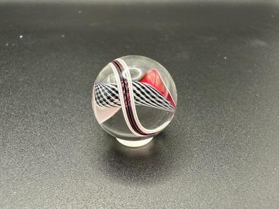 BLACK AND WHITE LATTICINIO CORE MARBLE WITH WHITE, RED, BLACK RIBBONS