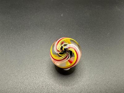 YELLOW AND BLACK STRIPED CORE MARBLE CAGED IN WHITE, PINK, RED AND YELLOW SWIRLS