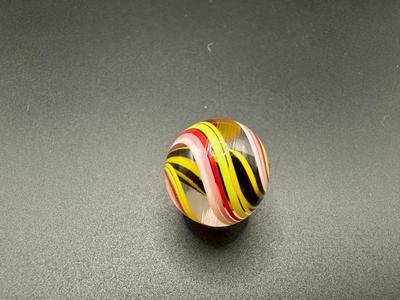 YELLOW AND BLACK STRIPED CORE MARBLE CAGED IN WHITE, PINK, RED AND YELLOW SWIRLS