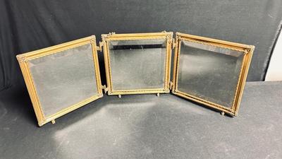 EARLY 20TH CENTURY ORMOLU BARBER MIRROR WITH A LEATHER RAISED DECORATIVE MOTIF